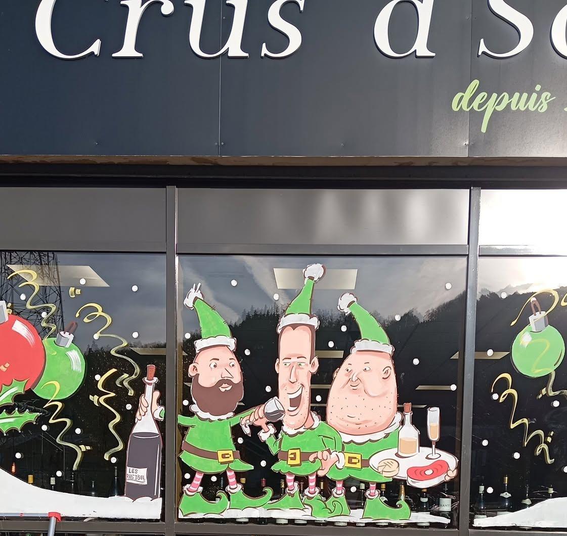 Vitrine de la cave Crus d'Sol : trois lutins caricaturés trinquant avec vin, champagne et fromages